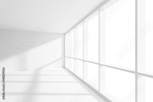 Empty white room with sunlight from large window.