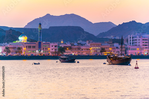 View of coastline of Muttrah district of Muscat during sunset, Oman.