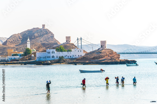 Local fishermen are getting on their boats on their way to the sea in Sur, Oman. photo