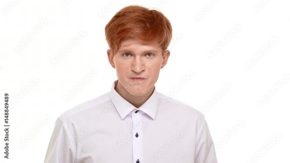 Angry young redhead Caucasian man standing on white background ready to fight Angry young redhead Caucasian man standing on white background ready to fight