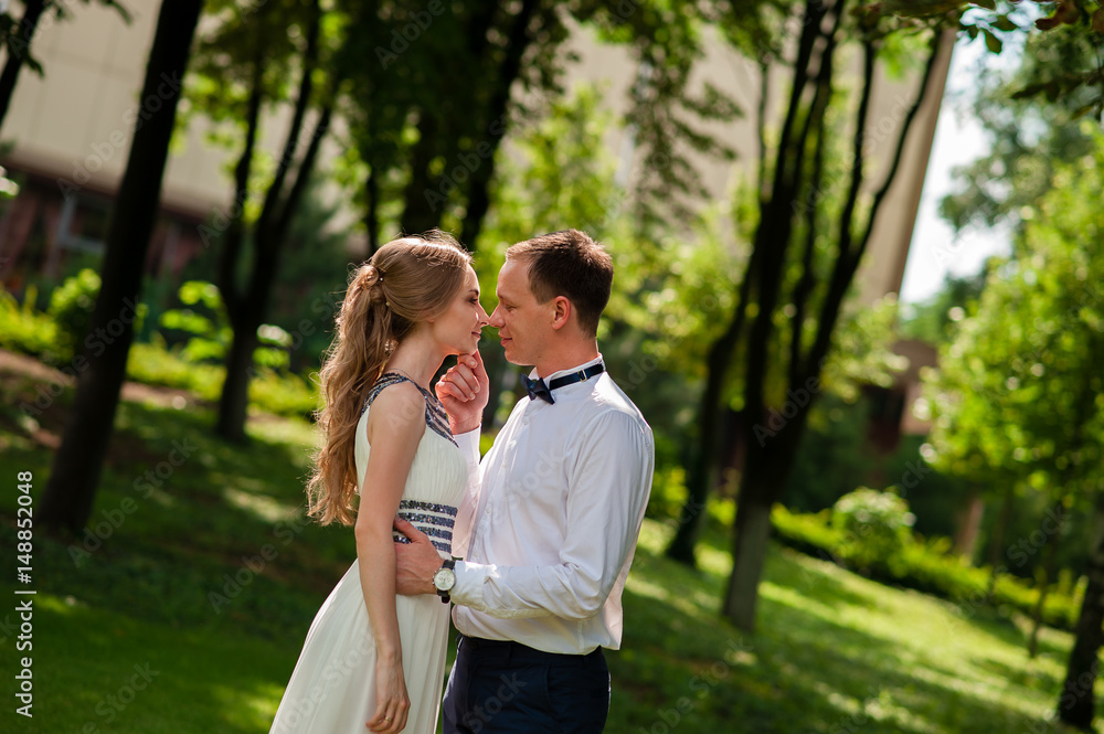 A married couple is walking and hugging in the park. A married couple is walking and hugging in the park.