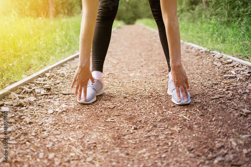 Cropped shot of woman runner stretching 
