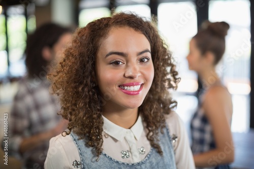 Smiling young woman standing in restaurant © WavebreakMediaMicro