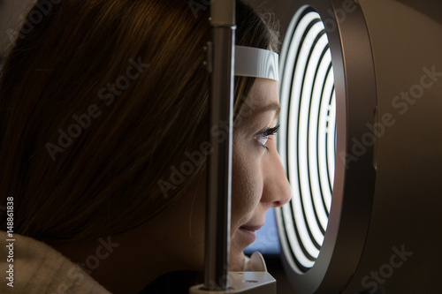 patient in corneal topograph at opticians shop photo