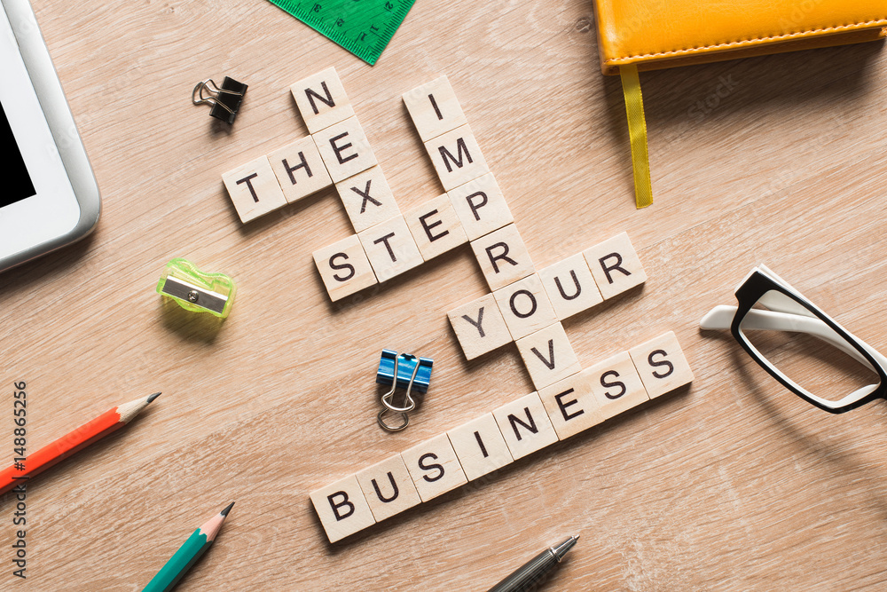 Conceptual business keywords on table with elements of game making crossword Conceptual business keywords on table with elements of game making crossword