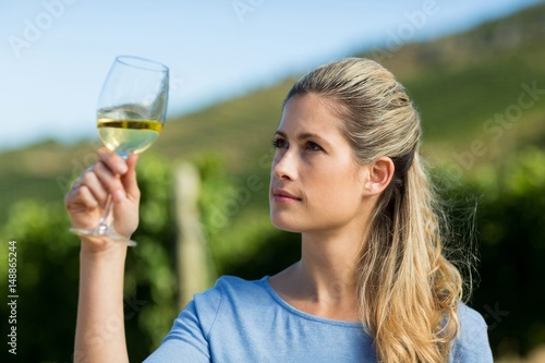Woman looking at wine in glass
