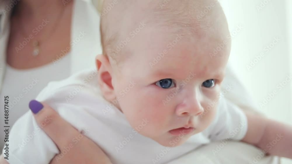 mother with a newborn baby dressed in white mother with a newborn baby dressed in white