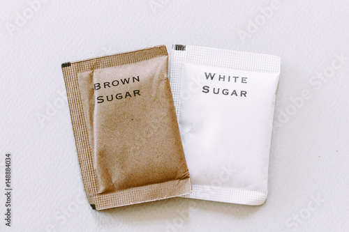 White and brown sugar bag on white background