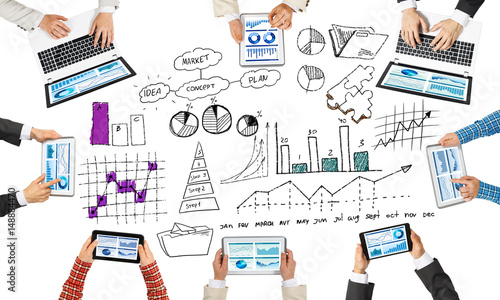 Top view of businesspeople sitting at table and using gadgets
