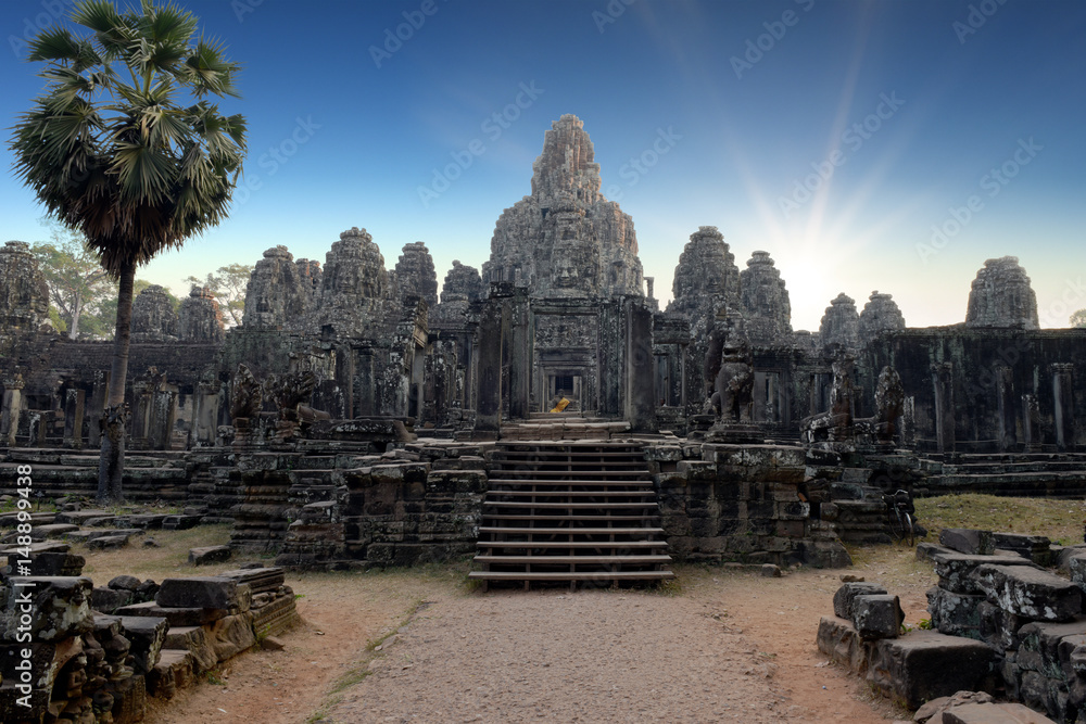 Fototapeta premium faces, heads of ancient Bayon Temple at Angkor Wat during sunrise, Siem Reap, Cambodia 