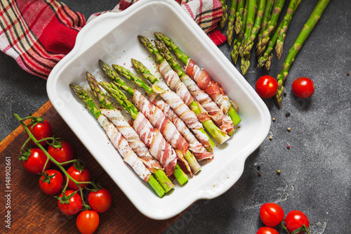 Baked green asparagus wrapped with bacon photo