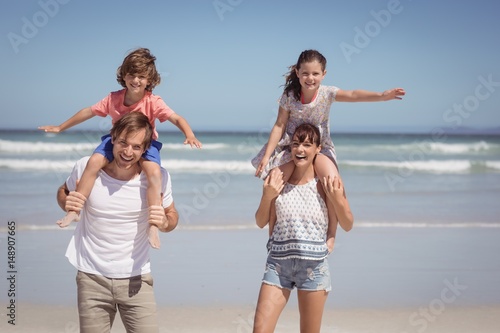 Portrait of cheerful family standing at beach