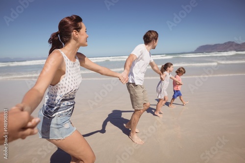Family holding hands at beach