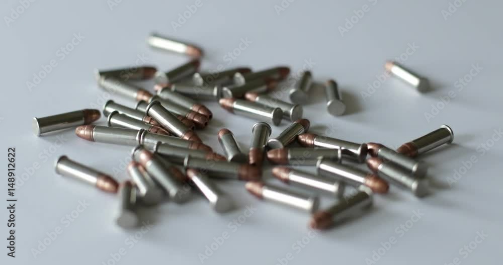 Scattered .22 bullet shells on a white surface Scattered .22 bullet shells on a white surface