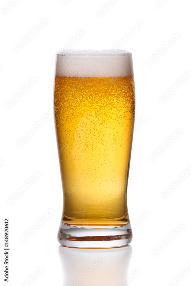 Frosty glass of light beer with foam on white . Frosty glass of light beer with foam on white .