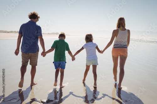 Rear view of family holding hands 