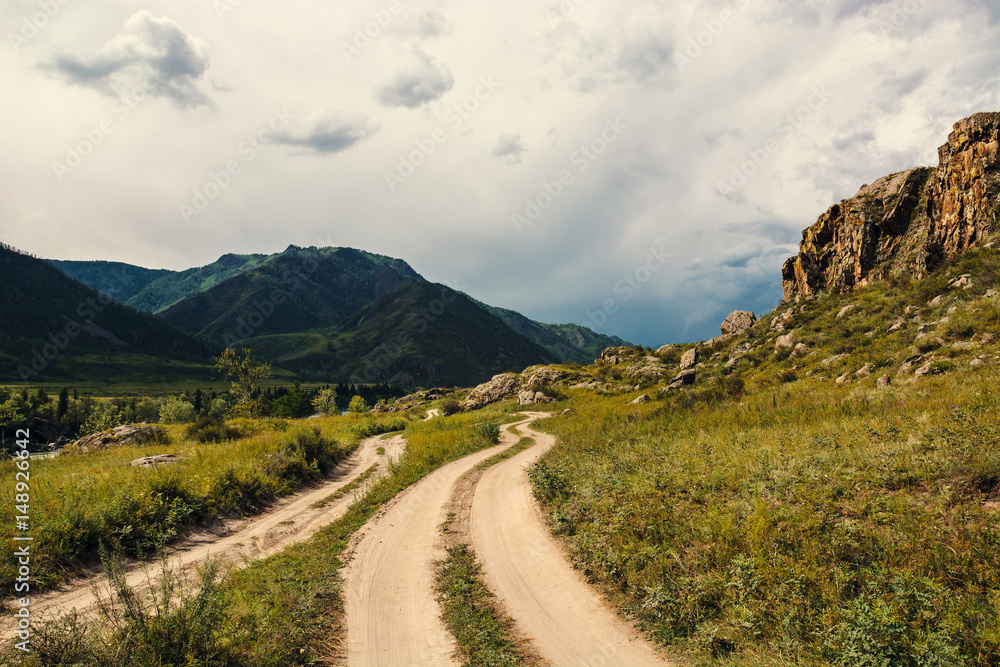 Road in a mountainous area. Picturesque landscape of Altai nature.