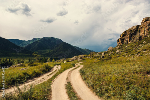 Road in a mountainous area. Picturesque landscape of Altai nature.