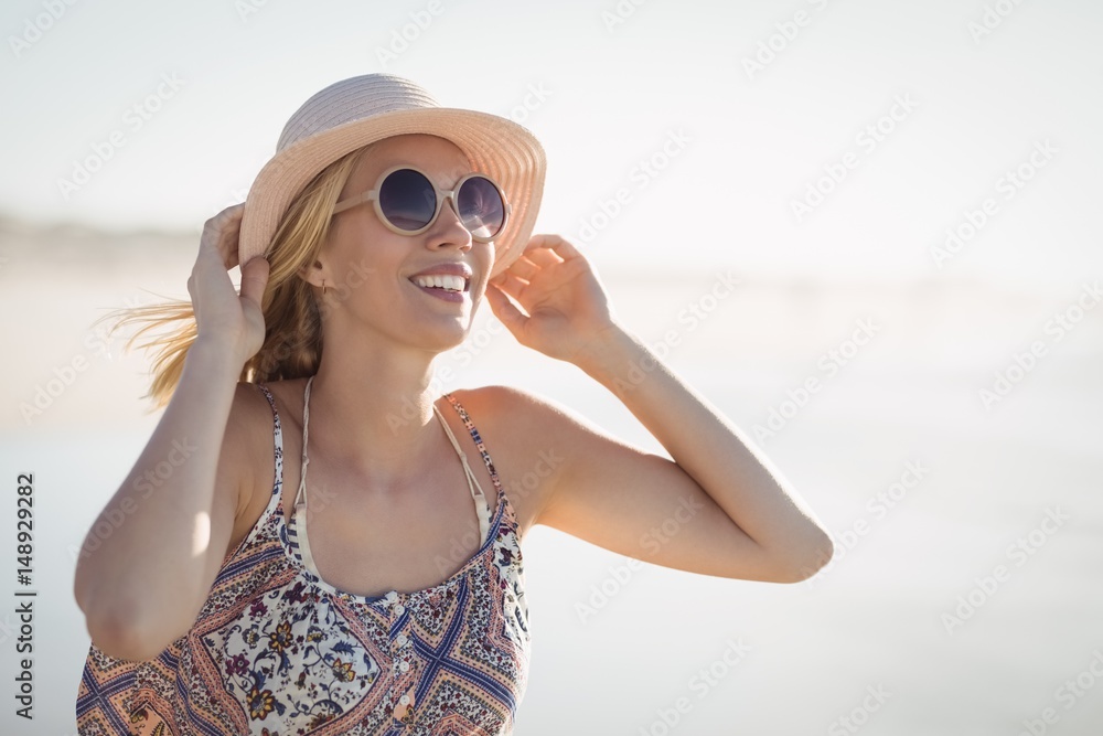 Young woman wearing sunglasses and hat at beach Young woman wearing sunglasses and hat at beach