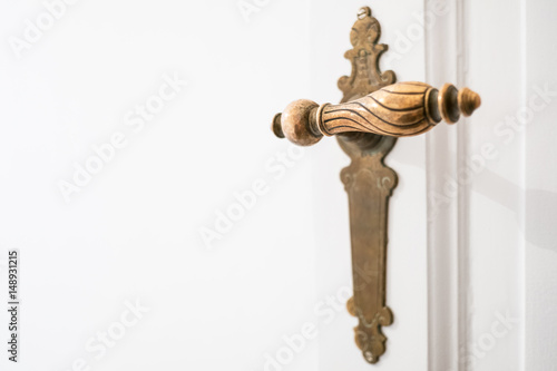 beautiful old door handle on white door