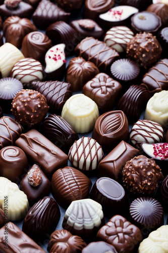 Assortment of fine chocolate candies Sweets background. Copy space. Top view