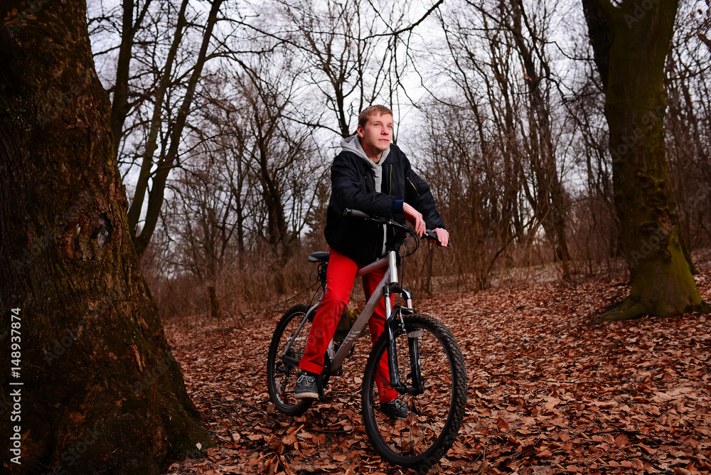 Cyclist Riding the Bike on a Trail in Summer Forest Cyclist Riding the Bike on a Trail in Summer Forest