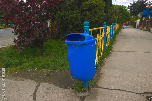 Trash bin by road in countryside.