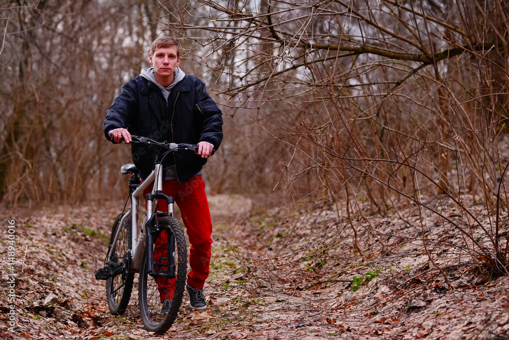 cyclist riding a mountain bike along the forest road cyclist riding a mountain bike along the forest road
