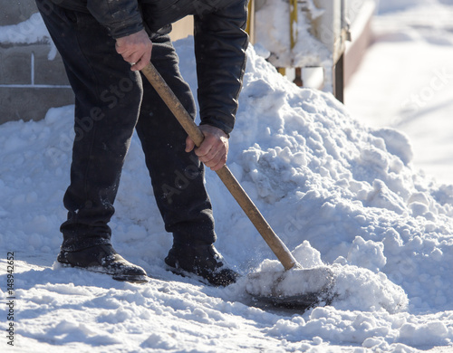 Worker cleans snow shovel © schankz