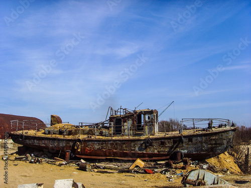 An old broken rusty ship on land
