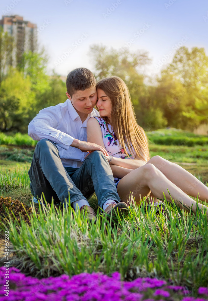 Portrait of young love couple in the garden Portrait of young love couple in the garden
