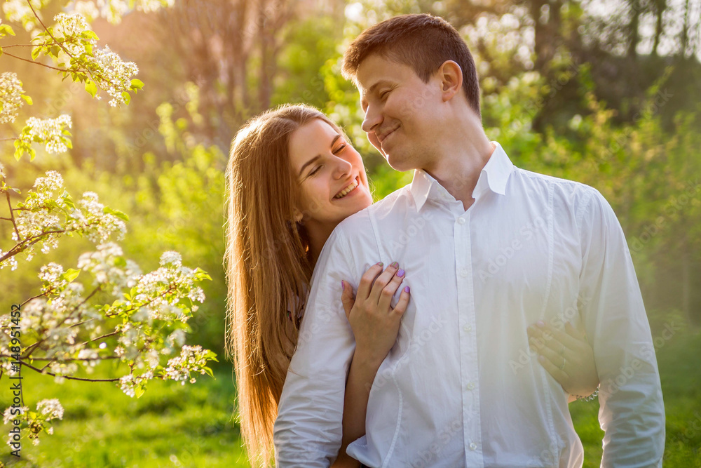 Portrait of young love couple in the garden Portrait of young love couple in the garden
