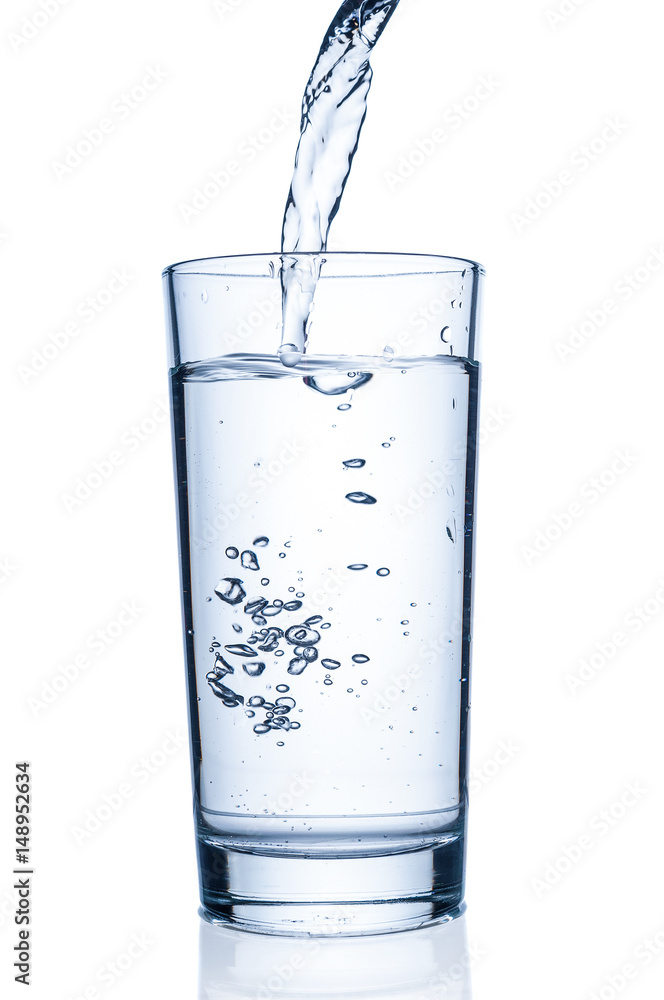 Pouring water into glass on white background Pouring water into glass on white background