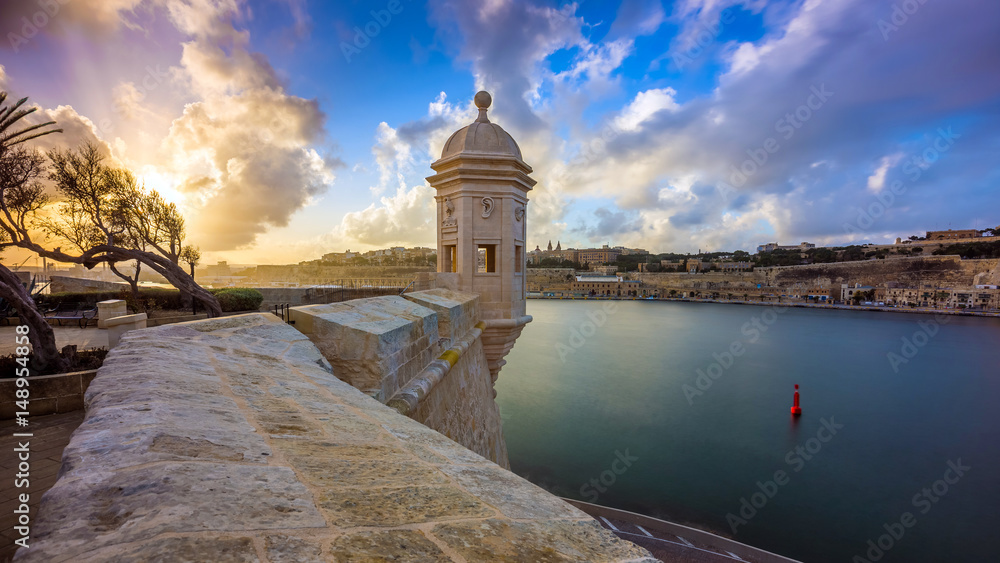 Senglea, Malta - Watch tower at Fort Saint Michael, Gardjola Gardens at sunset with beautiful sky and clouds