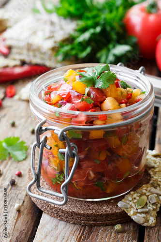 Tomato salsa with chili in a glass jar