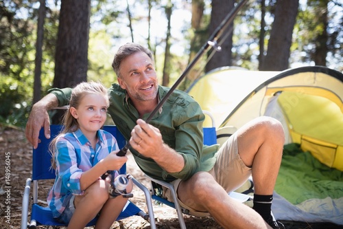 Father and daughter fishing at campsite in forest © WavebreakMediaMicro