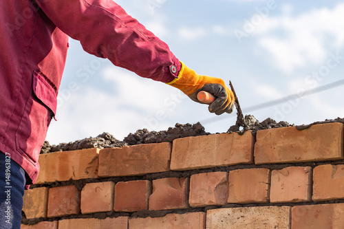 Worker builds a brick wall in the house