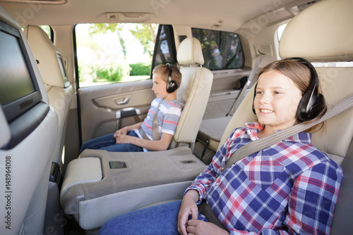 Kids riding car and watching movies photo