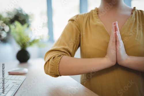 Executive meditating in office