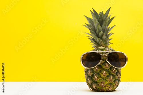 Summertime pineapple fruit with sunglasses