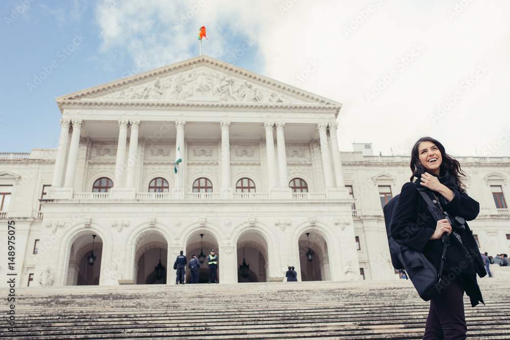 Female tourist standing in front of the Parliament of Portugal,Assembly of the Republic.Beautiful architecture of Assembleia da República.Walking woman visitor admiring São Bento Palace,Lisbon