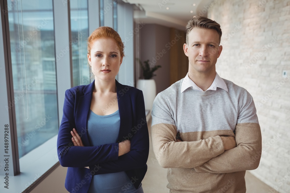 Portrait of executives standing with arms crossed Portrait of executives standing with arms crossed