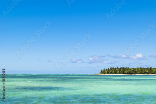 Equatorial part of the ocean with turquoise water  tropical island background