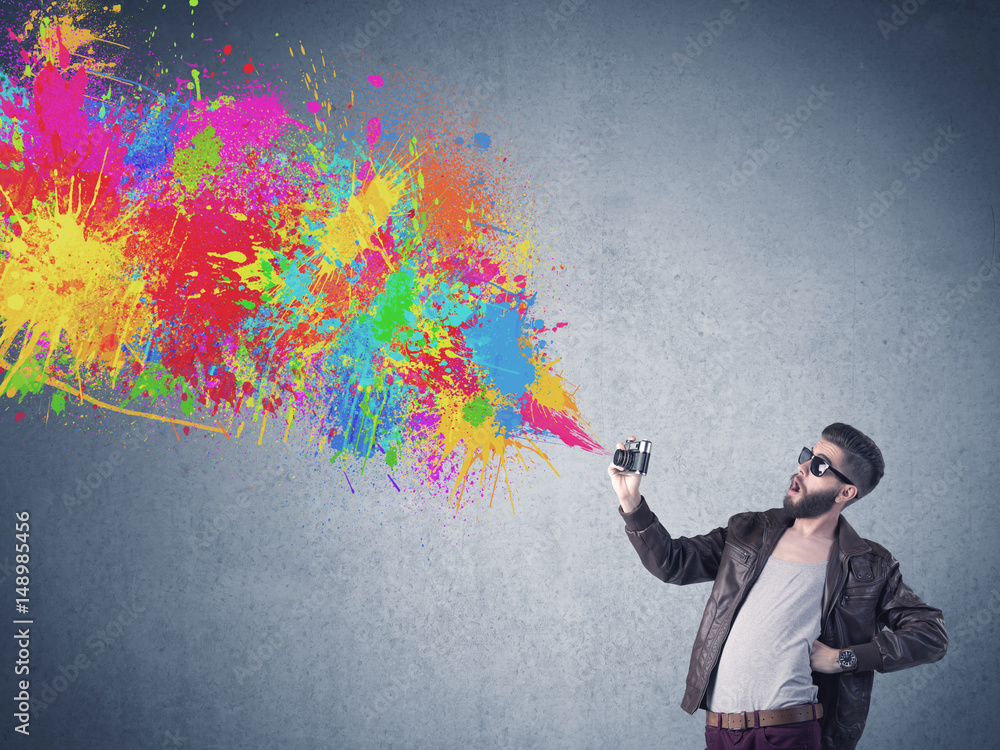 Hipster guy with camera and paint splash Hipster guy with camera and paint splash