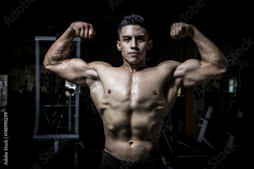 Young man exercising in dark and old gym