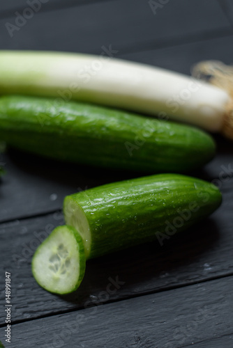 Vegetables ginger lime avocado cut in two pisces cucumber parsley leeks on wooden background