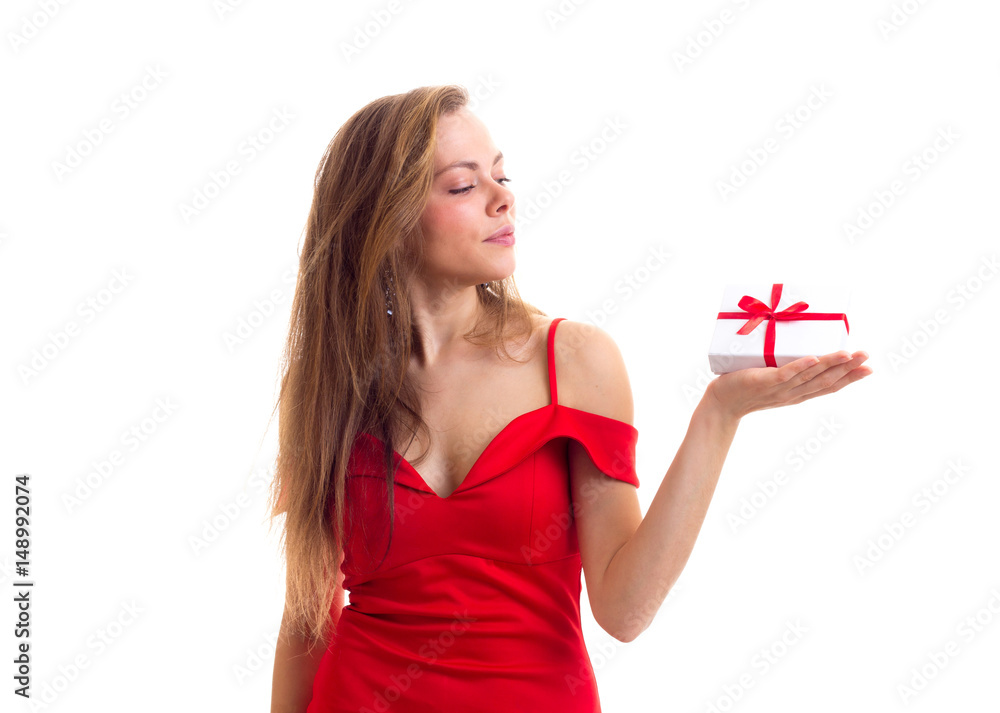 Young woman in red dress holding present Young woman in red dress holding present