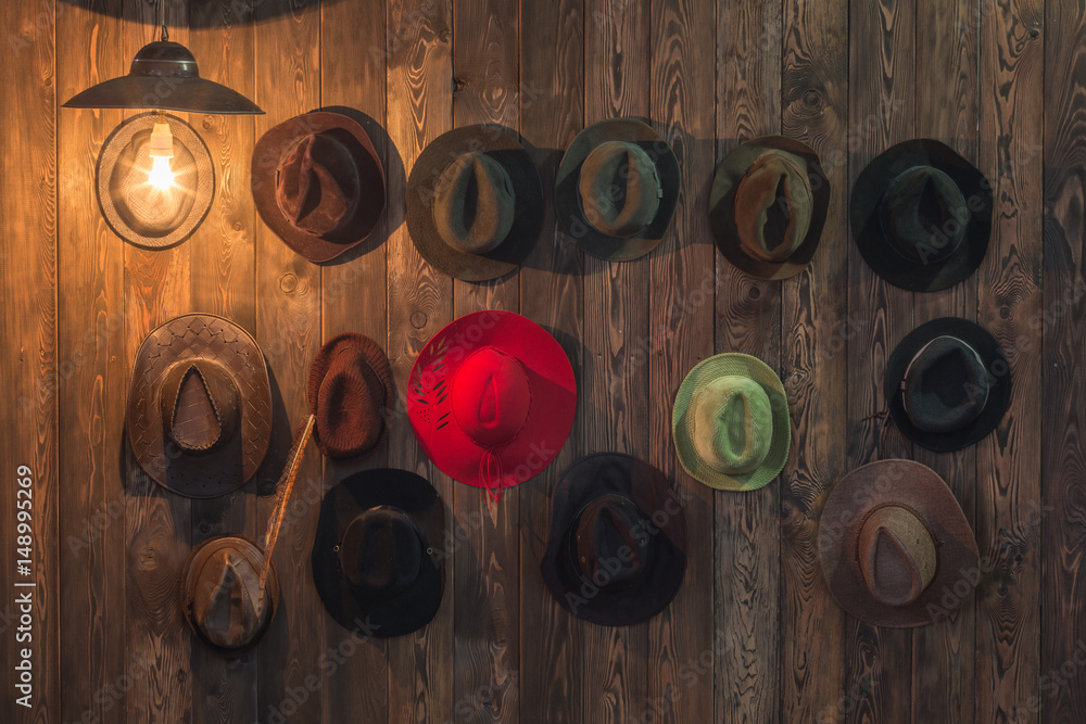 Old hats hang on a wooden wall Old hats hang on a wooden wall