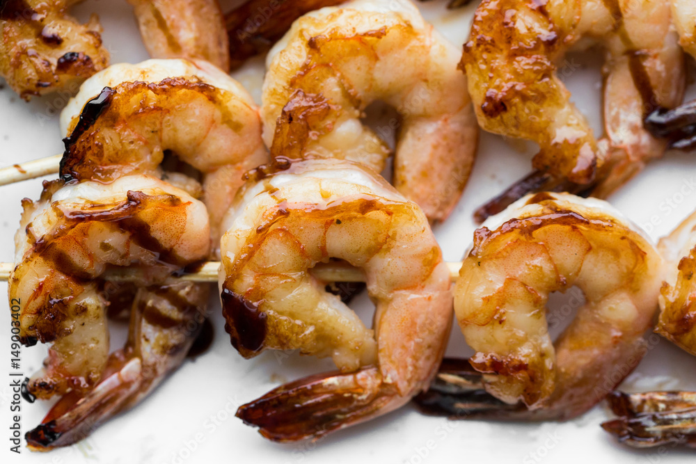 tasty spiced shrimp skewers on a barbecue tasty spiced shrimp skewers on a barbecue