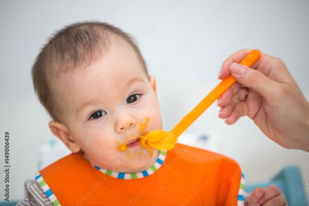 Baby laughing during lunch time. (6 months old). Baby laughing during lunch time. (6 months old).